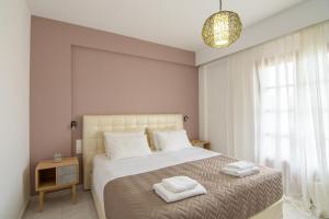 a bedroom with a bed with two towels on it at The Wave in Sidari