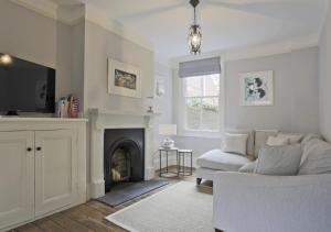 a living room with a couch and a fireplace at Bay House in Southwold