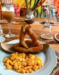 a plate of food with onion rings on a table at Hotel Casa La Pilonera in Valledupar