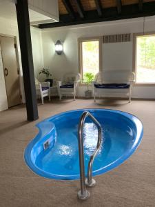 a large blue tub in the middle of a room at Hideaway Mountain Lodge in Fraser