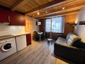 ラ・クリュサにあるParnasse 2-203 - Bel appartement sur les pistes de ski et dans le village, au calmeのリビングルーム(ソファ付)、キッチン、テーブルが備わります。