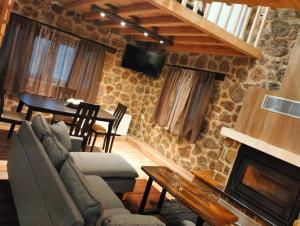 a living room with a couch and a fireplace at Erofili in Kato Trikala Korinthias
