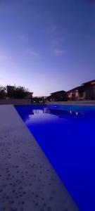 una piscina con luces azules en el agua en Estrella del Alma en Capilla del Monte
