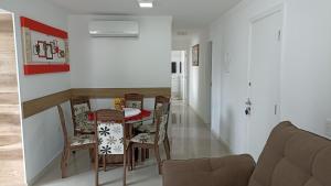 a kitchen and dining room with a table and chairs at Apto temporada Itapema sc in Itapema