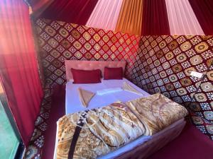 a bedroom with a bed in a tent at Desert shine camp in Wadi Rum