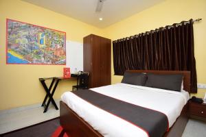 a bedroom with a bed and a painting on the wall at Gokul Residency Near Emami City Nager bazar in Dum Dum