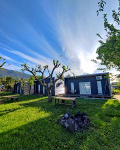 a tiny house sitting on top of a lush green field at Cabañas Koyam in Melipeuco