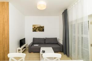 a living room with a couch and a table at City Castle Apartments Free Parking in Bratislava