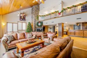 a living room with leather furniture and a christmas tree at 313 Iron Horse Way #C4083 in Winter Park