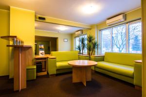 a waiting room with a couch and a table at Zvezda Hotel in Minsk
