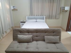 a living room with a couch and a bed at Estúdio Palace Hotel Canela By Cia da Temporada in Canela +15 photos
