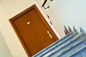 a wooden door in the corner of a room at Residence La Casetta in Loano