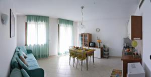 a living room with a blue couch and a table at Residence La Casetta in Loano