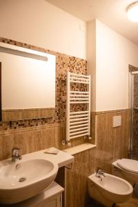 een badkamer met een wastafel, een toilet en een spiegel bij Lovely studio steps from Basilica Santa Croce in Florence
