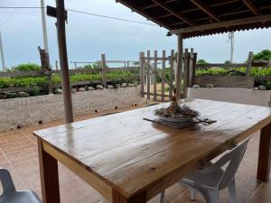 a wooden table and chairs on a patio at SaBriMo in Dibulla