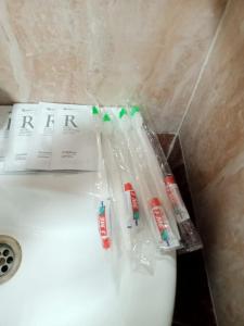a bunch of toothbrushes are sitting on top of a sink at Аппартоменты in Shchūchīnsk