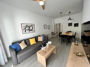 a living room with a couch and a table at PUSHE Playa Granada Beach & Golf 12 in Motril