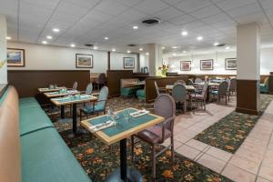 a restaurant with tables and chairs in a room at Ramada by Wyndham Reno Hotel & Casino in Reno