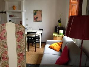 a living room with a couch and a table at Lovelyloft Navigli - Gelsomino in Milan