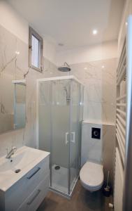 a bathroom with a shower and a toilet and a sink at Pavillon Lilly in Menton