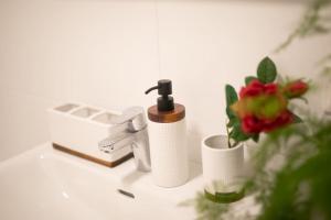 a bathroom sink with a faucet and two cups at Schönes Living am Donauufer in Vienna