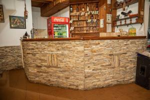 a bar in a restaurant with a brick wall at Стария Чинар Мелник in Melnik