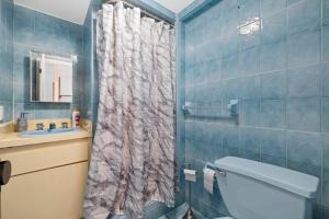 a bathroom with a shower with a toilet and a sink at Little Havana Retreat - Newly remodeled Villa by Loan Depot Stadium! in Miami