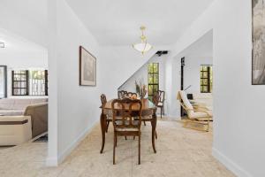 a living room with a table and chairs and a couch at Little Havana Retreat - Newly remodeled Villa by Loan Depot Stadium! in Miami