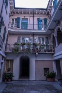 an apartment building with potted plants on the balconies at BRIXIA LUXORY & LOFT in Brescia