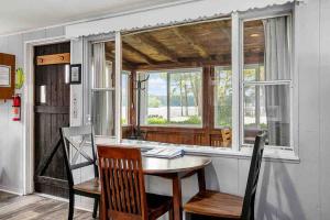 a dining room with a table and a window at Pet friendly cabin with dock, firepit, grill, bikes in Newaygo