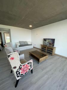 - un salon avec un canapé et une table dans l'établissement North Beach GHF, à Costa Esmeralda