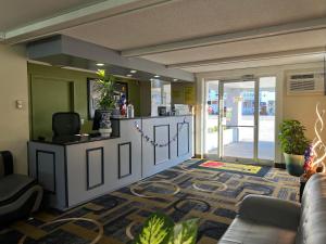 a lobby with a waiting room with a couch and a counter at Super 8 by Wyndham Bangor in Bangor