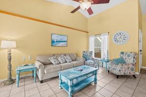 a living room with a couch and chairs and a ceiling fan at Heart of the Waves - 3BR & 2BA Beach Retreat - NEW HOT TUB - Outside Patio with Grill & Seating, Steps to Fun! in Melbourne