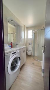 a bathroom with a washing machine and a toilet at Sea Sparkle 1a in Preveza +39 photos