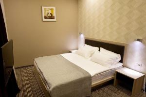 Postel nebo postele na pokoji v ubytování Kiroff Hotel