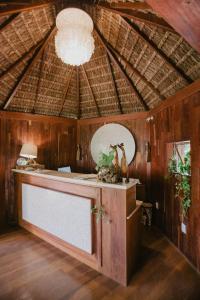 a room with a counter and a ceiling with a chandelier at Paua Hotel Boutique in Pipa
