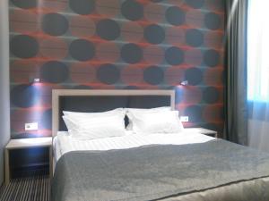 Postel nebo postele na pokoji v ubytování Kiroff Hotel