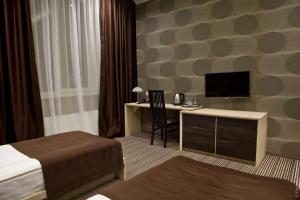 Postel nebo postele na pokoji v ubytování Kiroff Hotel
