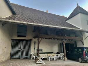 ein Haus mit einer Terrasse mit einem Tisch und Stühlen in der Unterkunft Grand family home in the heart of Burgundy! in Saint-Berain-sur-Dheune