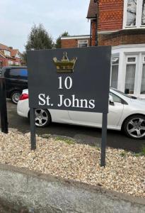 a sign for a street with a car parked in a parking lot at Flat 8, 10 St Johns in Bournemouth