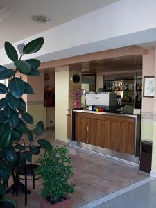 a restaurant with a counter and a bar at Hotel Monica in Chianciano Terme