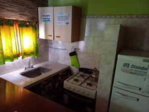 una piccola cucina con fornelli e lavello di CRISNANBEL a Las Grutas