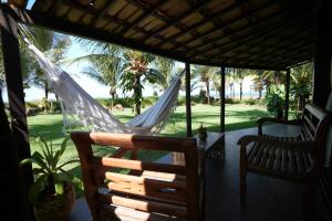 two hammocks on the porch of a house at Paua Hotel Boutique in Pipa