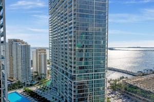 an aerial view of a tall building next to the water at ICON Brickell residences in Miami