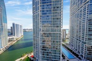 a view of a river between two tall buildings at ICON Brickell residences in Miami