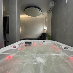 a bath tub filled with water in a bathroom at TEPIĆ Garni Hotel in Temerin