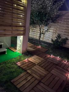 a deck with lights on the grass at night at Appartement rez de chaussée avec parking privé in Orléans