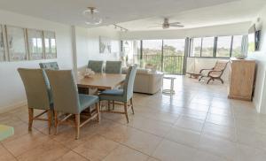 a dining room and living room with a table and chairs at SEA MIST - Oceanfront-Lake-Kayak-Paddleboard-Bike in Key Largo