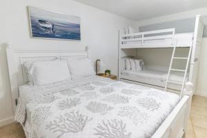 a bedroom with a bunk bed and a ladder at SEA MIST - Oceanfront-Lake-Kayak-Paddleboard-Bike in Key Largo +53 photos