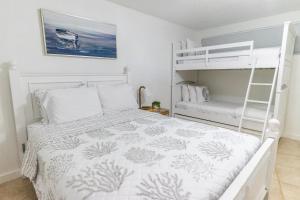 a bedroom with a bunk bed and a ladder at SEA MIST - Oceanfront-Lake-Kayak-Paddleboard-Bike in Key Largo